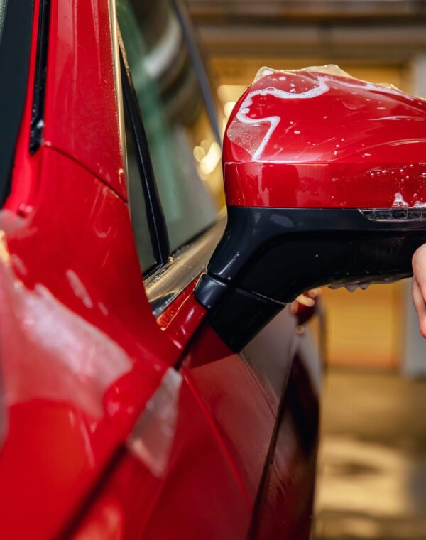 Master man installs vinyl film protect paint body side mirrors car.